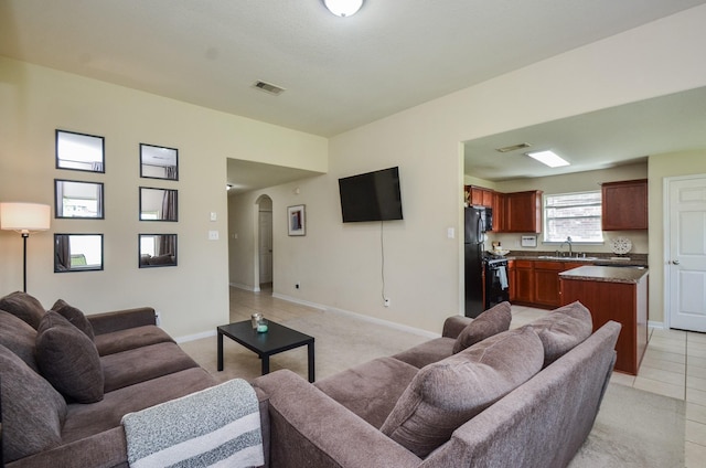 2122 Platinum Mist Dr, Rosharon, TX 77583 - living room with arched walkways and light tile patterned flooring