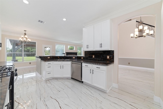 23703 Shaw Perry Ln, Katy, TX 77493 - kitchen featuring a chandelier, appliances with stainless steel finishes, arched walkways, light marble finish flooring, and white cabinets