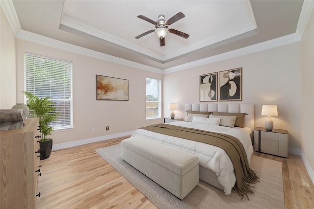 23703 Shaw Perry Ln, Katy, TX 77493 - bedroom with light wood-type flooring, a tray ceiling, crown molding, and a ceiling fan
