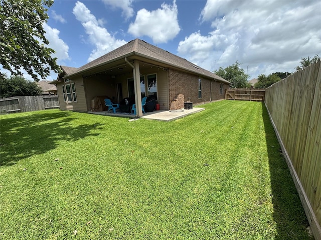 907 Fairway Dr, La Porte, TX 77571 - back of house with a patio, brick siding, a fenced backyard, and a shingled roof