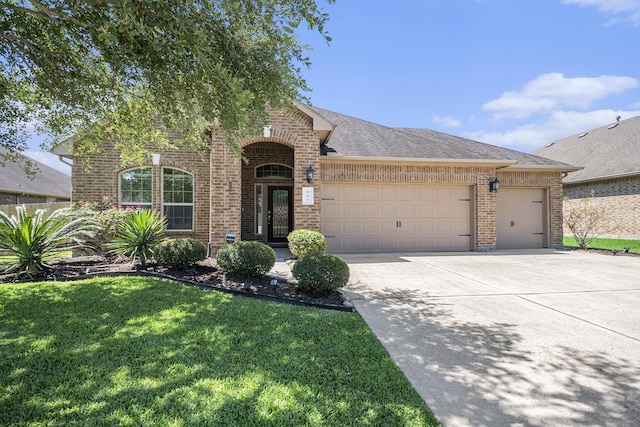 907 Fairway Dr, La Porte, TX 77571 - view of front of property featuring brick siding, an attached garage, a front lawn, concrete driveway, and roof with shingles