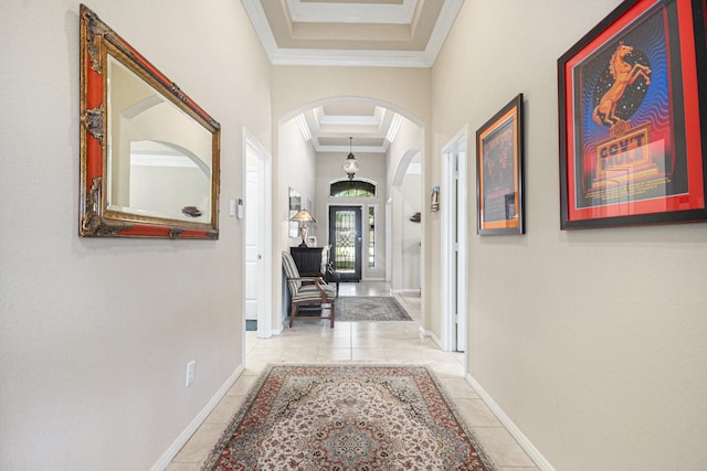 907 Fairway Dr, La Porte, TX 77571 - corridor featuring arched walkways, ornamental molding, light tile patterned floors, and a tray ceiling