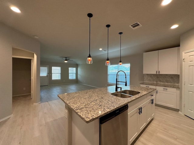 4215 Stuebner Hill Dr, Houston, TX 77068 - kitchen with stainless steel dishwasher, ceiling fan, recessed lighting, light wood-style floors, and backsplash