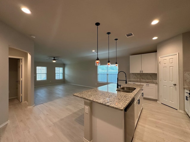4215 Stuebner Hill Dr, Houston, TX 77068 - kitchen with dishwasher, light wood-style flooring, ceiling fan, recessed lighting, and white cabinetry