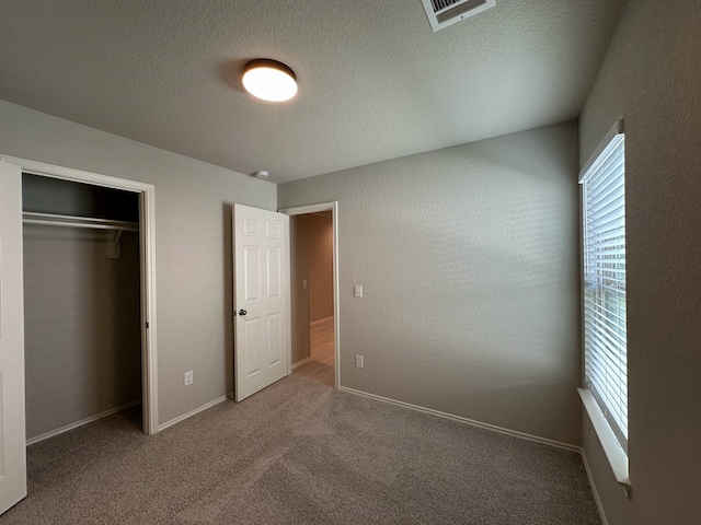 4215 Stuebner Hill Dr, Houston, TX 77068 - unfurnished bedroom featuring carpet, a closet, and a textured ceiling