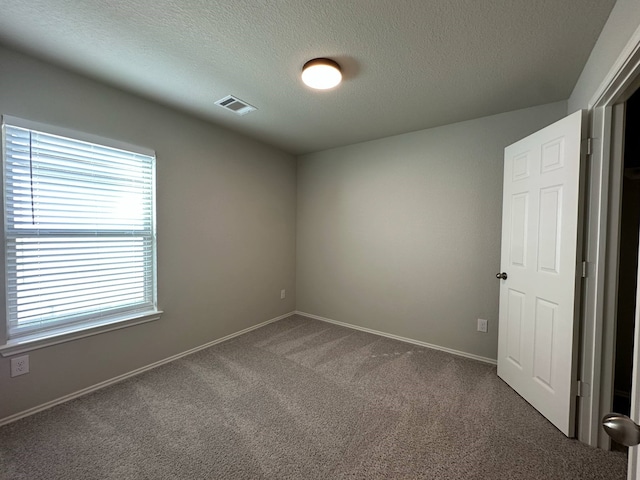 4215 Stuebner Hill Dr, Houston, TX 77068 - carpeted empty room featuring a textured ceiling and baseboards