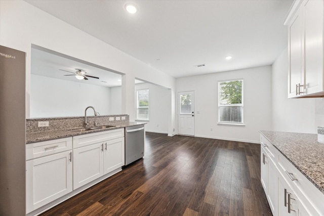 10122 Clearwick St, Houston, TX 77034 - kitchen featuring stainless steel dishwasher, dark wood-style flooring, light stone counters, white cabinets, and recessed lighting