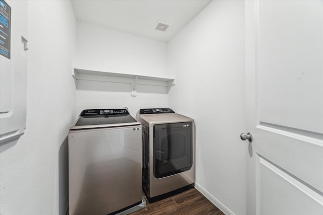 10122 Clearwick St, Houston, TX 77034 - laundry area with dark wood-style flooring and washer and clothes dryer