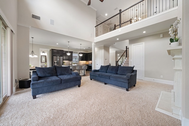 19522 Hope Springs Ln, Cypress, TX 77433 - living area featuring light carpet, a towering ceiling, ceiling fan, recessed lighting, and ornamental molding