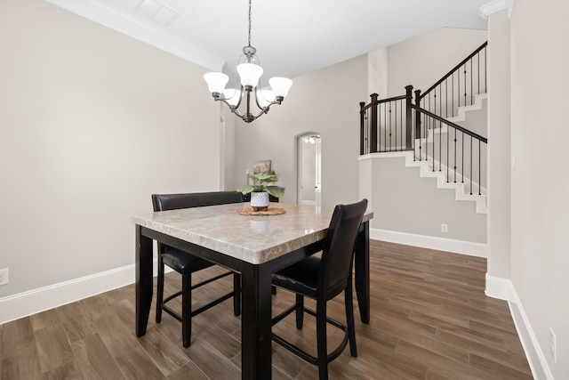 19522 Hope Springs Ln, Cypress, TX 77433 - dining space featuring a chandelier, dark wood-style flooring, stairs, and crown molding