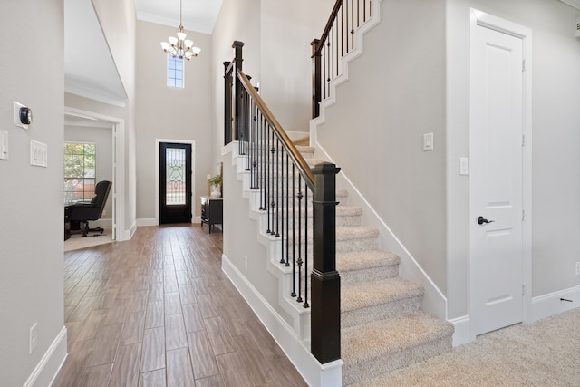 19522 Hope Springs Ln, Cypress, TX 77433 - foyer entrance featuring a chandelier, ornamental molding, stairway, and wood finished floors