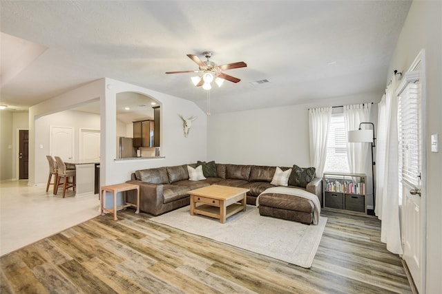 115 Meadow Ridge Way, Clute, TX 77531 - living room with a ceiling fan, wood finished floors, and arched walkways