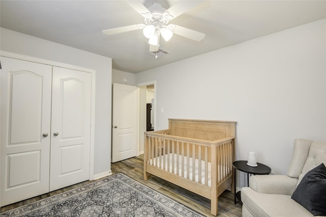 115 Meadow Ridge Way, Clute, TX 77531 - bedroom featuring wood finished floors, a closet, a crib, and ceiling fan