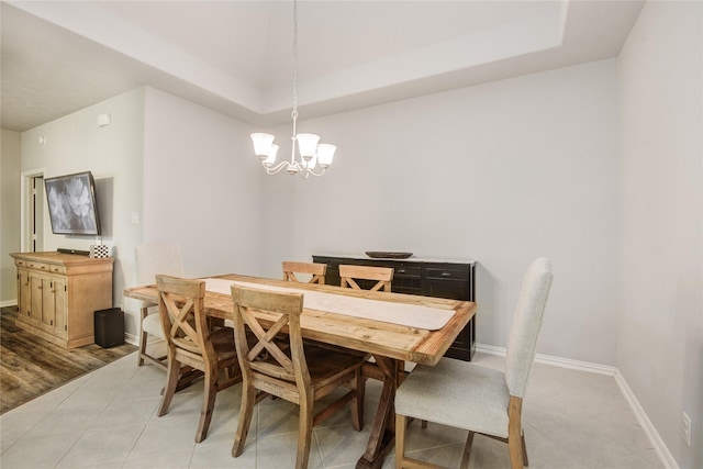115 Meadow Ridge Way, Clute, TX 77531 - dining area featuring a chandelier, light tile patterned floors, and a tray ceiling