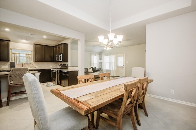 115 Meadow Ridge Way, Clute, TX 77531 - dining room with a chandelier, light tile patterned floors, and recessed lighting
