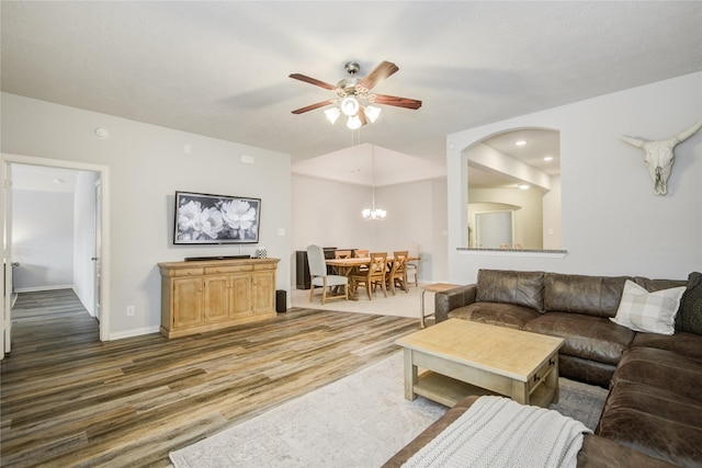 115 Meadow Ridge Way, Clute, TX 77531 - living room featuring ceiling fan, wood finished floors, arched walkways, and a chandelier