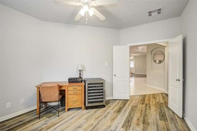 115 Meadow Ridge Way, Clute, TX 77531 - office area featuring wine cooler, a ceiling fan, and wood finished floors