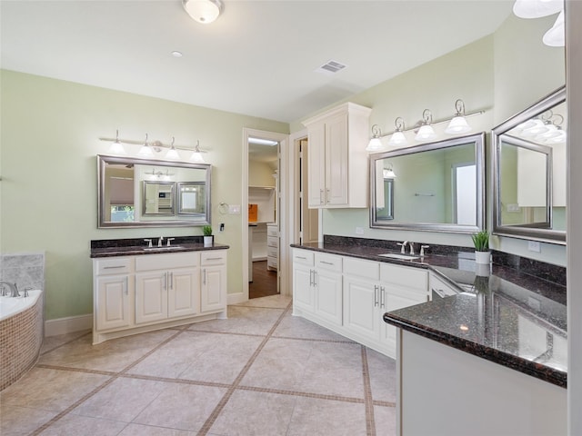 4635 Beech St, Bellaire, TX 77401 - full bathroom featuring two vanities, tile patterned flooring, and a bath