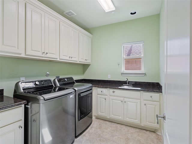 4635 Beech St, Bellaire, TX 77401 - washroom featuring washer and dryer, cabinet space, and light tile patterned floors