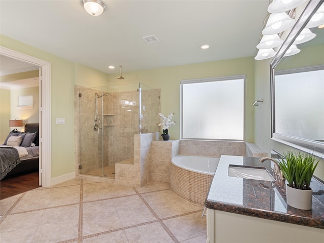 4635 Beech St, Bellaire, TX 77401 - ensuite bathroom featuring a stall shower, a garden tub, vanity, tile patterned flooring, and recessed lighting