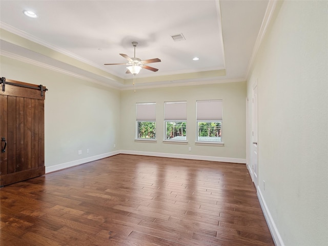 4635 Beech St, Bellaire, TX 77401 - empty room with wood finished floors, a ceiling fan, a barn door, ornamental molding, and a tray ceiling