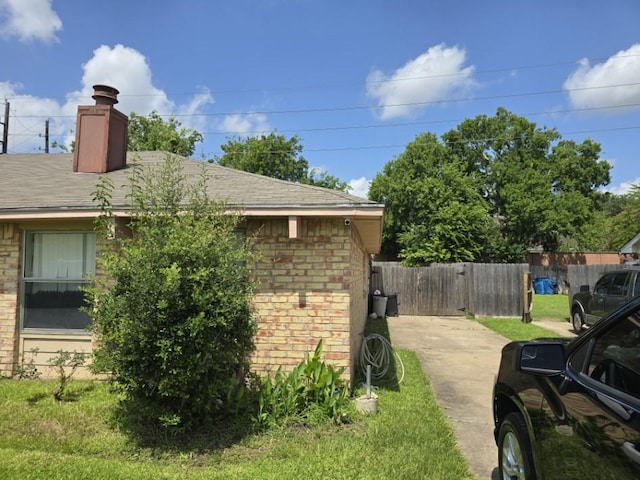 3902 Quiet Place Dr, Houston, TX 77082 - view of side of property featuring brick siding, a chimney, and a shingled roof