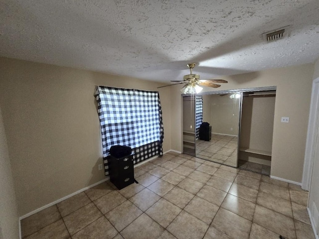 3902 Quiet Place Dr, Houston, TX 77082 - unfurnished bedroom with a textured ceiling, light tile patterned flooring, and a ceiling fan