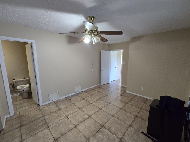 3902 Quiet Place Dr, Houston, TX 77082 - unfurnished room with a ceiling fan, light tile patterned floors, and a textured ceiling