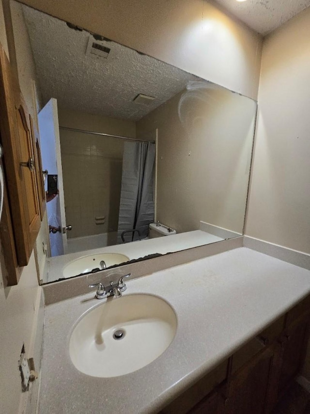 3902 Quiet Place Dr, Houston, TX 77082 - bathroom with a textured ceiling, a shower with shower curtain, and vanity