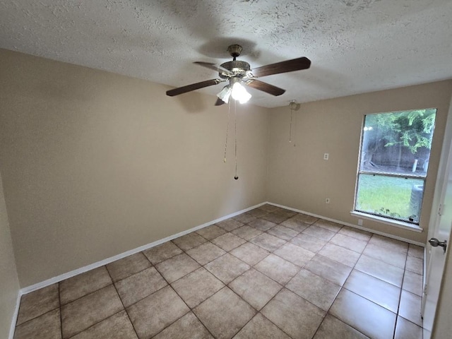 3902 Quiet Place Dr, Houston, TX 77082 - empty room with a textured ceiling, ceiling fan, and light tile patterned flooring