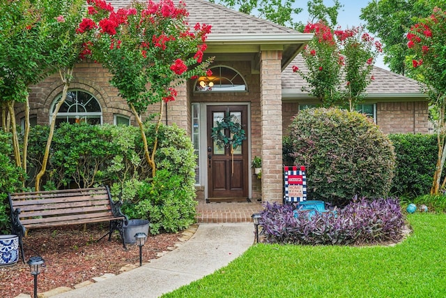 1095 Gladstone Dr, League City, TX 77573 - doorway to property featuring a shingled roof and brick siding