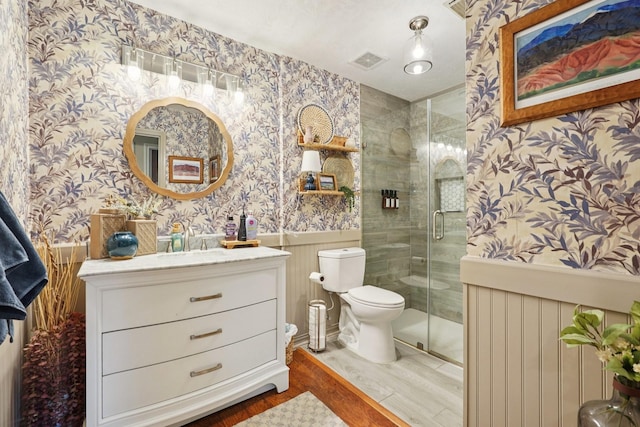 1095 Gladstone Dr, League City, TX 77573 - full bathroom with wallpapered walls, vanity, a wainscoted wall, a stall shower, and wood finished floors