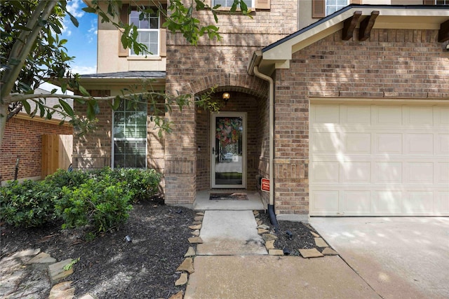 9859 Clanton Pines Dr, Humble, TX 77396 - doorway to property featuring an attached garage and brick siding