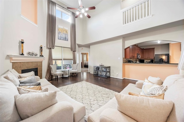 9859 Clanton Pines Dr, Humble, TX 77396 - living area with a towering ceiling, ceiling fan, plenty of natural light, wood finished floors, and arched walkways