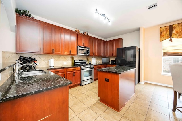 9859 Clanton Pines Dr, Humble, TX 77396 - kitchen with stainless steel appliances, backsplash, dark stone counters, and light tile patterned floors