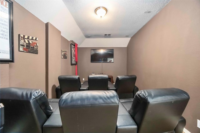9859 Clanton Pines Dr, Humble, TX 77396 - home theater room with a textured ceiling and lofted ceiling