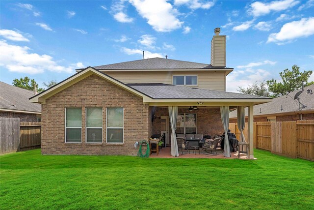 9859 Clanton Pines Dr, Humble, TX 77396 - back of property featuring a patio area, ceiling fan, a fenced backyard, a chimney, and brick siding