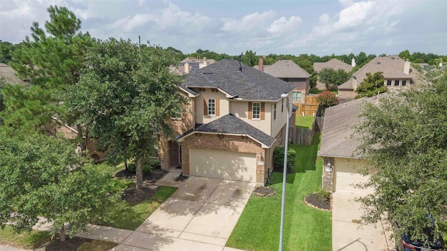 9859 Clanton Pines Dr, Humble, TX 77396 - traditional-style home featuring a garage, stucco siding, concrete driveway, brick siding, and a shingled roof