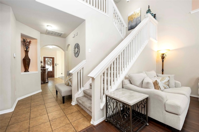 9859 Clanton Pines Dr, Humble, TX 77396 - stairway featuring arched walkways and tile patterned flooring