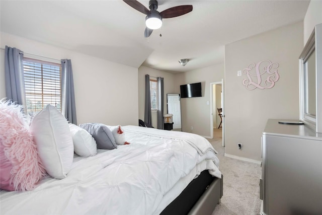9859 Clanton Pines Dr, Humble, TX 77396 - bedroom with multiple windows, light carpet, and ceiling fan