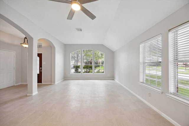 20703 Surrey Stone Ct, Katy, TX 77450 - empty room featuring a ceiling fan, arched walkways, vaulted ceiling, and light tile patterned floors