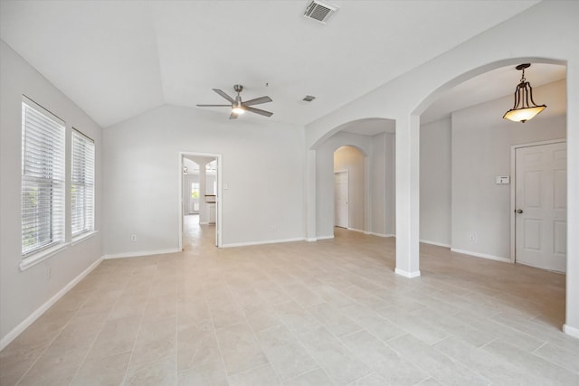 20703 Surrey Stone Ct, Katy, TX 77450 - unfurnished living room featuring a ceiling fan, vaulted ceiling, arched walkways, and light tile patterned flooring