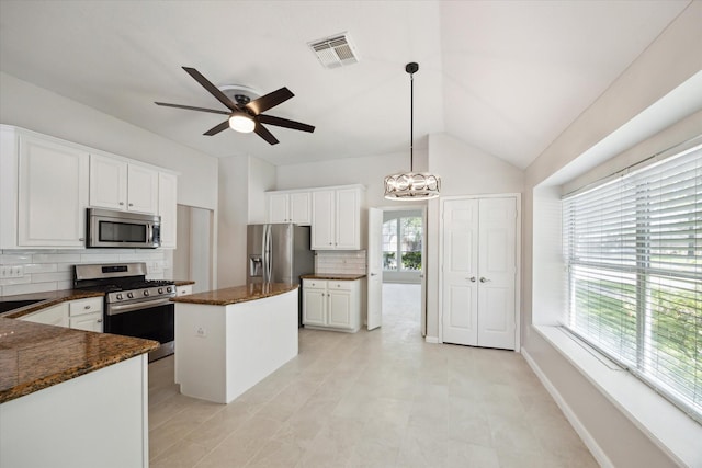 20703 Surrey Stone Ct, Katy, TX 77450 - kitchen featuring appliances with stainless steel finishes, backsplash, a kitchen island, white cabinetry, and a ceiling fan