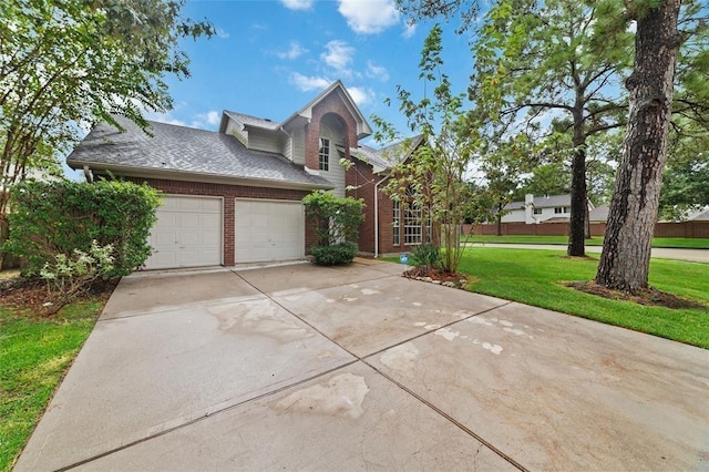 1102 Indian Autumn Trce, Houston, TX 77062 - traditional-style house with brick siding, a front lawn, driveway, a garage, and a shingled roof