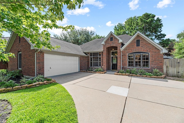 16307 Rainbow Lake Rd, Houston, TX 77095 - traditional home with an attached garage, brick siding, concrete driveway, and a shingled roof