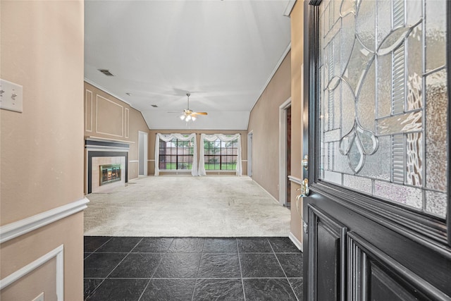 16307 Rainbow Lake Rd, Houston, TX 77095 - entryway with dark carpet, ceiling fan, a tile fireplace, and lofted ceiling