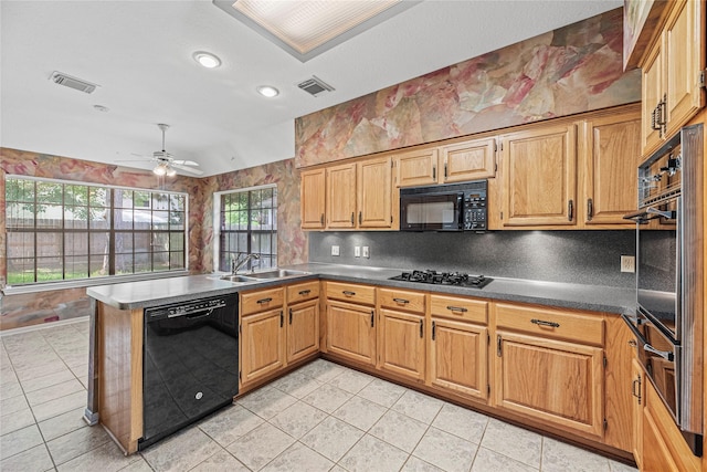 16307 Rainbow Lake Rd, Houston, TX 77095 - kitchen featuring black appliances, a peninsula, light tile patterned flooring, a warming drawer, and recessed lighting