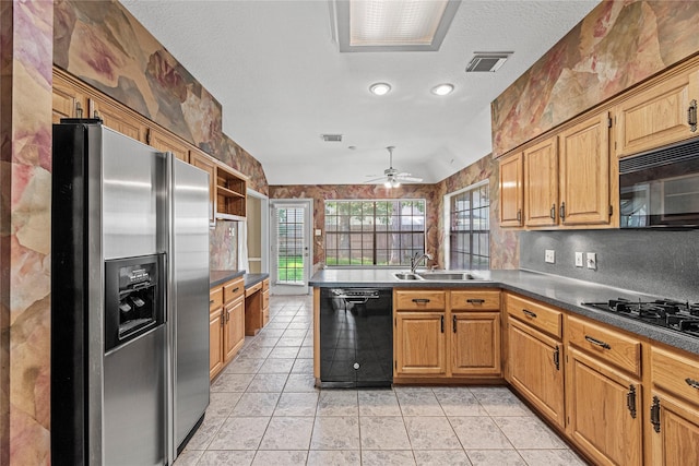 16307 Rainbow Lake Rd, Houston, TX 77095 - kitchen with black appliances, a peninsula, a ceiling fan, light tile patterned flooring, and dark countertops