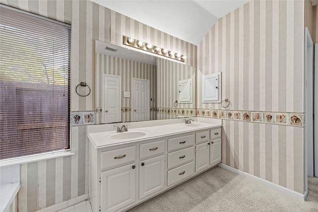 16307 Rainbow Lake Rd, Houston, TX 77095 - full bathroom featuring wallpapered walls, double vanity, and vaulted ceiling