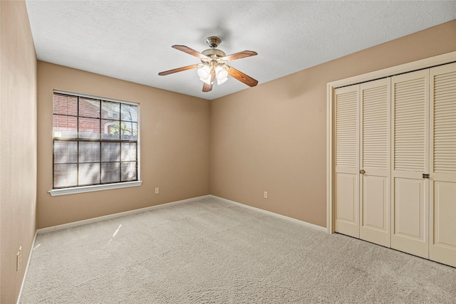16307 Rainbow Lake Rd, Houston, TX 77095 - unfurnished bedroom with carpet flooring, a closet, a ceiling fan, and a textured ceiling